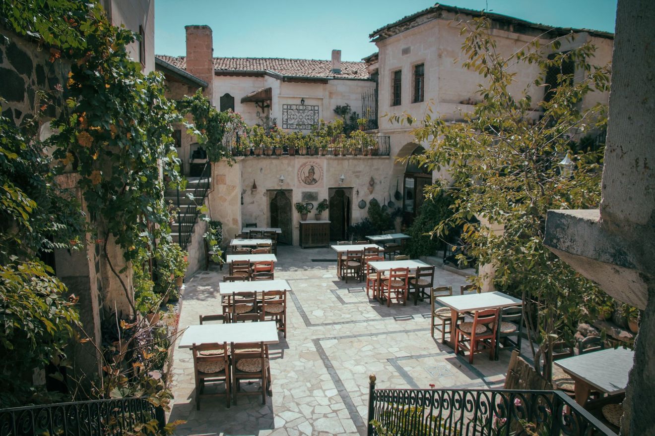 A welcoming courtyard with tables beneath the trees